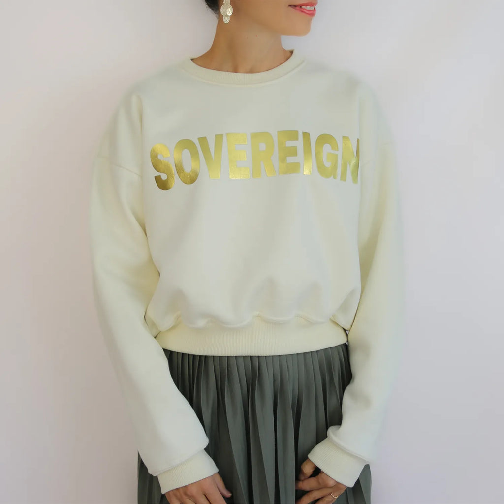 Sovereign gold and ivory sweatshirt by CocoMilkyWay, empowering statement piece blending softness and strength