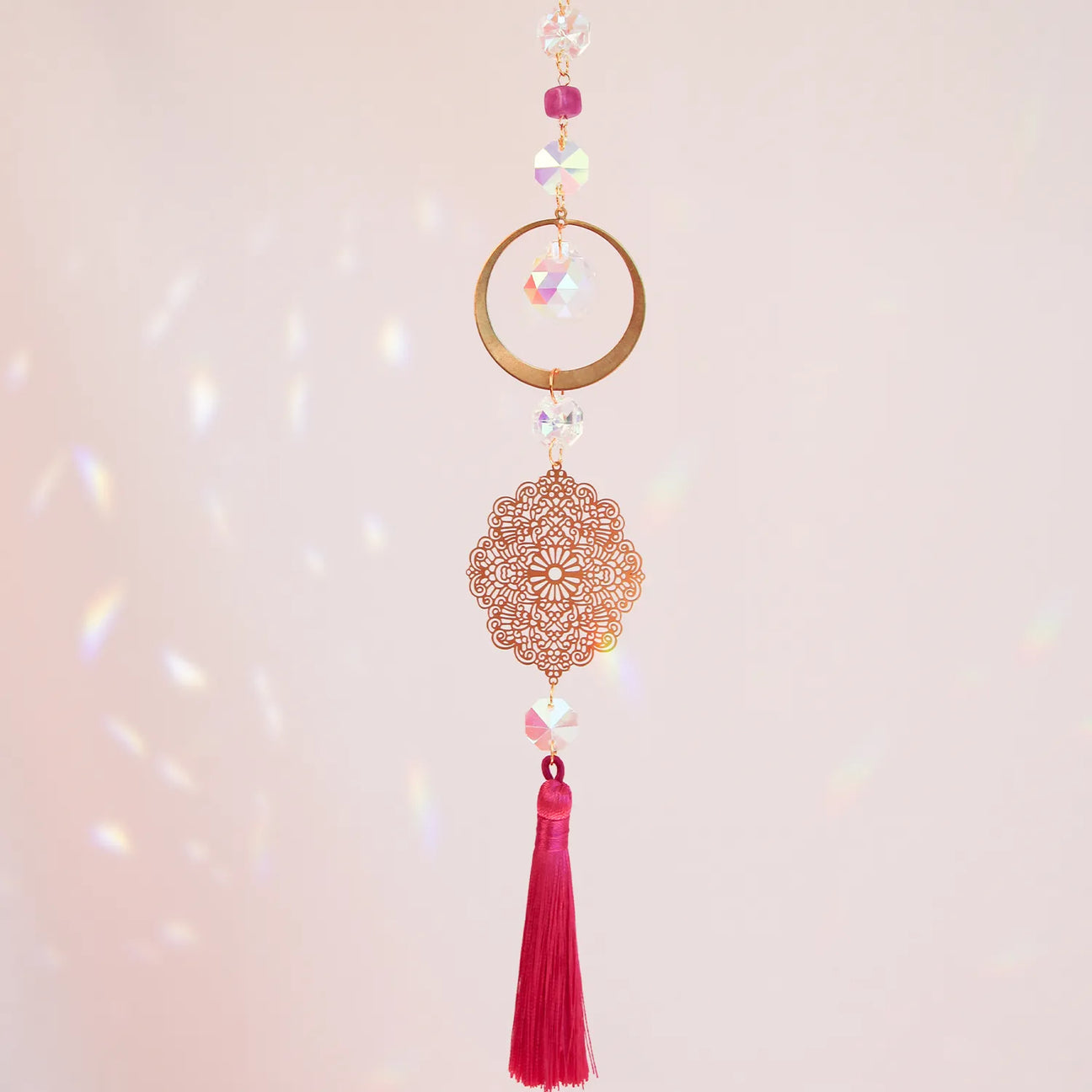 High Heart suncatcher with pink tassel by CocoMilkyWay, light-reflecting decor symbolizing love, compassion, and elevated energy